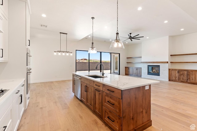 4845 W 2020 S, Hurricane, UT 84737 - kitchen with a sink, ceiling fan, recessed lighting, brown cabinets, and a center island with sink