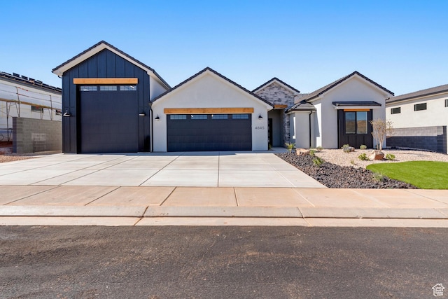 4845 W 2020 S, Hurricane, UT 84737 - view of front of house with an attached garage, concrete driveway, stucco siding, and board and batten siding