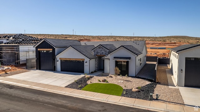 4845 W 2020 S, Hurricane, UT 84737 - modern farmhouse style home with concrete driveway, a garage, stucco siding, and fence