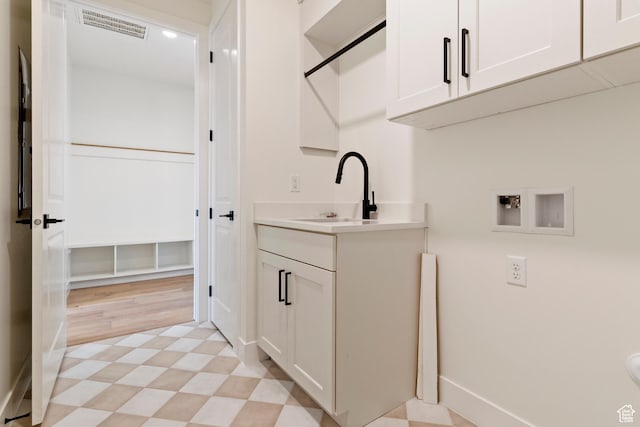 4845 W 2020 S, Hurricane, UT 84737 - washroom with washer hookup, light floors, cabinet space, and baseboards