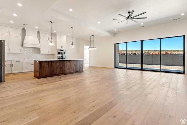 4845 W 2020 S, Hurricane, UT 84737 - kitchen with custom range hood, open floor plan, appliances with stainless steel finishes, recessed lighting, and tasteful backsplash
