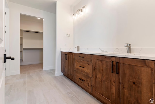 4845 W 2020 S, Hurricane, UT 84737 - full bathroom featuring a walk in closet, baseboards, and double vanity