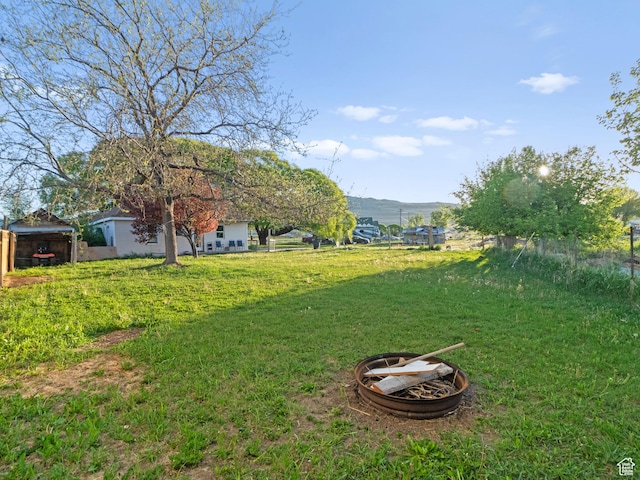 10045 W 12000 N, Bothwell, UT 84337 - view of green lawn featuring a mountain view and a fire pit