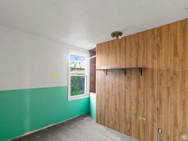 10045 W 12000 N, Bothwell, UT 84337 - carpeted empty room featuring wooden walls