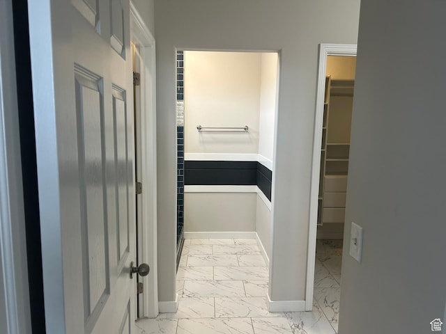 bathroom with marble look tiles and baseboards