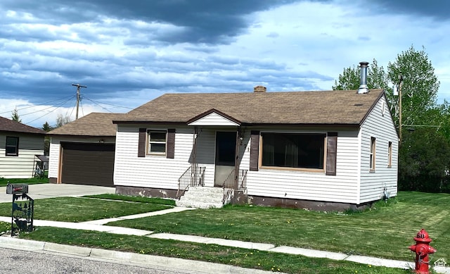 271 S Court St W, Soda Springs, ID 83276 - view of front of home with entry steps, a front lawn, a chimney, a shingled roof, and a detached garage