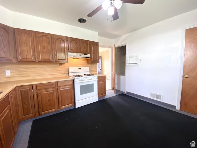 271 S Court St W, Soda Springs, ID 83276 - kitchen featuring white gas stove, under cabinet range hood, light countertops, ceiling fan, and backsplash