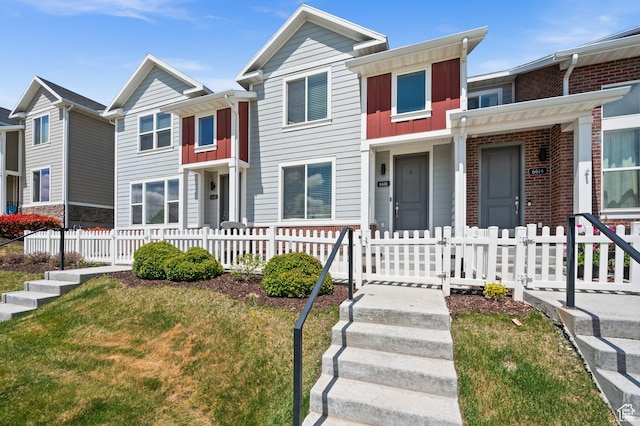 6616 W 7735 S, West Jordan, UT 84081 - view of property with board and batten siding and a fenced front yard