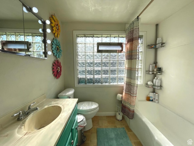 bathroom with healthy amount of natural light, tile patterned flooring, and vanity