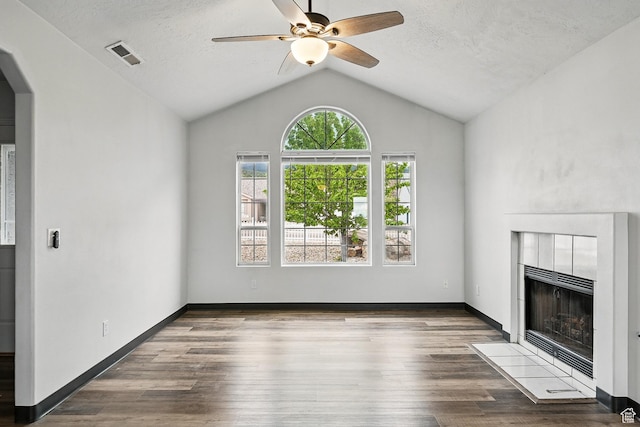 710 W 1350 S, Cedar City, UT 84720 - unfurnished living room featuring a ceiling fan, a tile fireplace, arched walkways, lofted ceiling, and wood finished floors