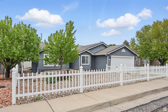 710 W 1350 S, Cedar City, UT 84720 - ranch-style home featuring an attached garage, stucco siding, a tile roof, a fenced front yard, and concrete driveway