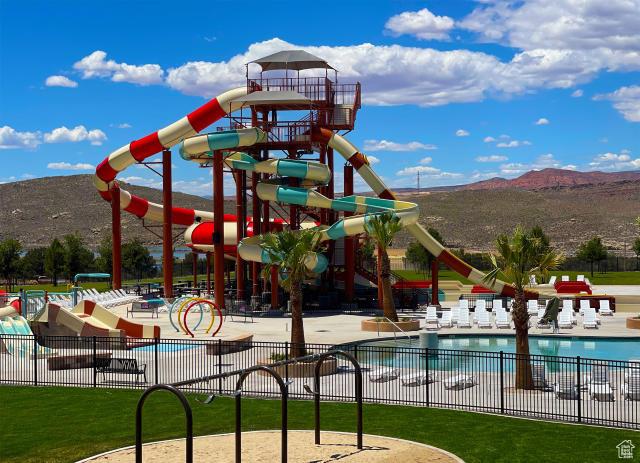 3335 W 2570 S, Hurricane, UT 84737 - view of play area with fence, a mountain view, a community pool, a patio area, and a water play area