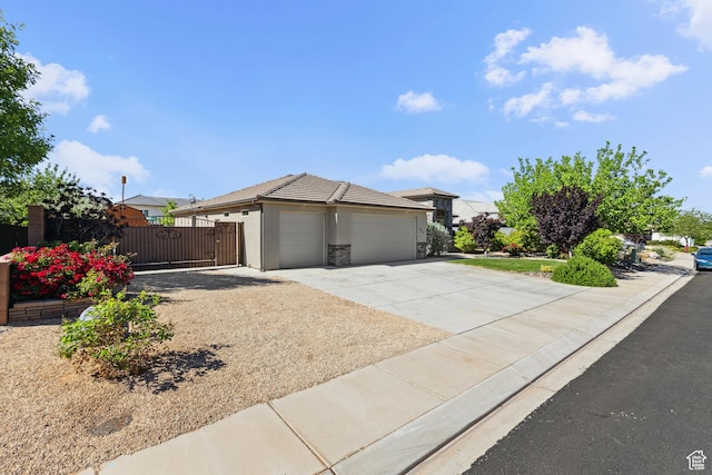 3335 W 2570 S, Hurricane, UT 84737 - view of front of home with a garage, concrete driveway, stucco siding, a gate, and fence