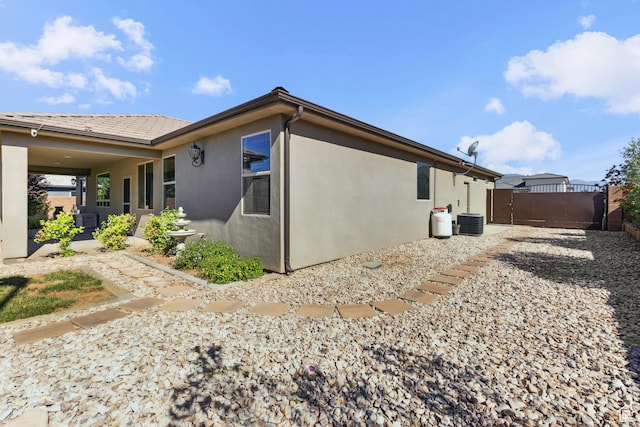 3335 W 2570 S, Hurricane, UT 84737 - view of home's exterior with a gate, stucco siding, central AC unit, and fence