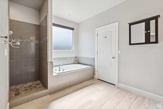 3335 W 2570 S, Hurricane, UT 84737 - bathroom featuring a bath, tiled shower, and wood finished floors