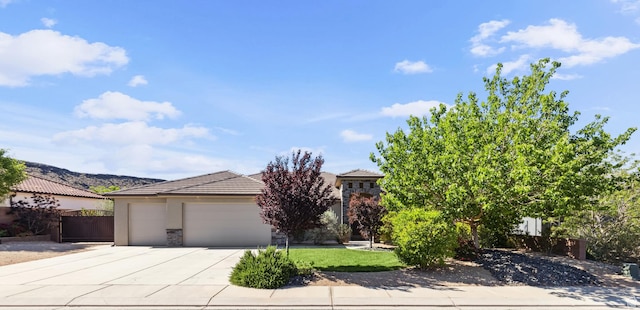 3335 W 2570 S, Hurricane, UT 84737 - obstructed view of property with an attached garage, driveway, stucco siding, fence, and a tiled roof