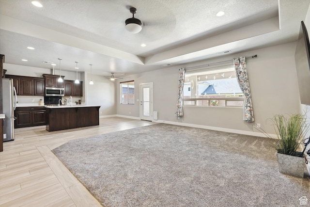 3335 W 2570 S, Hurricane, UT 84737 - unfurnished living room with ceiling fan, baseboards, recessed lighting, a raised ceiling, and a textured ceiling
