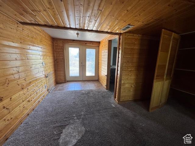 bonus room with wood ceiling, french doors, wooden walls, and carpet flooring