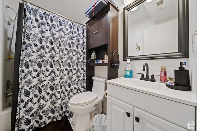 full bathroom with toilet and vanity