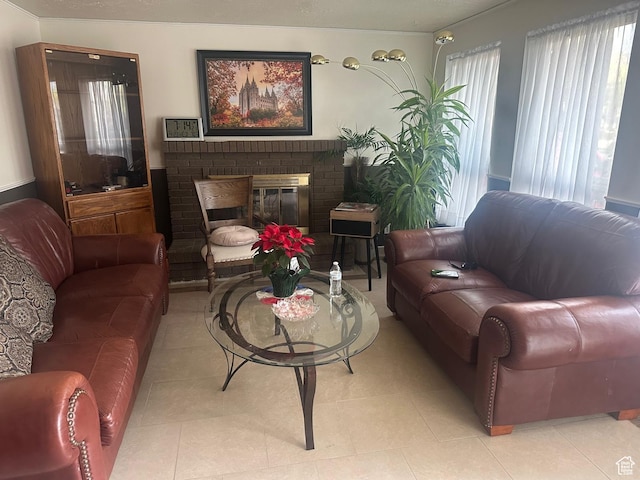 living area with a fireplace and light tile patterned floors