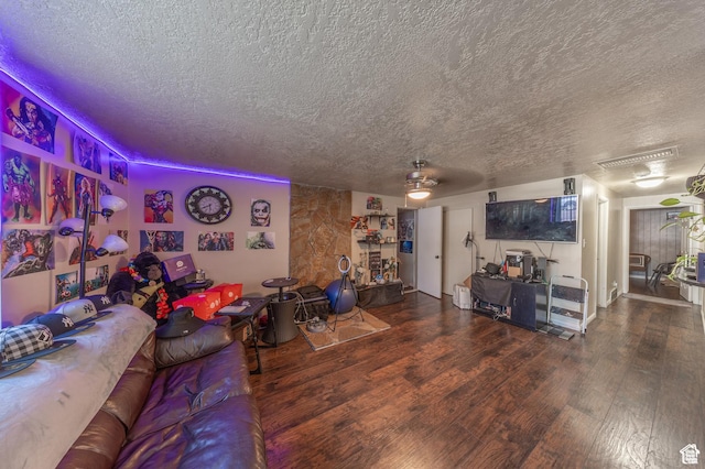 living area with wood finished floors and a textured ceiling