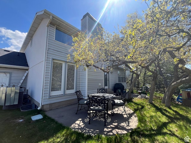 4863 Glasmann Way, Ogden, UT 84403 - back of house featuring a patio, a yard, and a chimney
