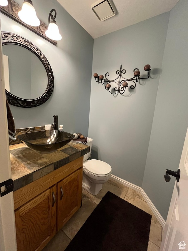 4863 Glasmann Way, Ogden, UT 84403 - half bath featuring vanity, toilet, tile patterned flooring, and baseboards