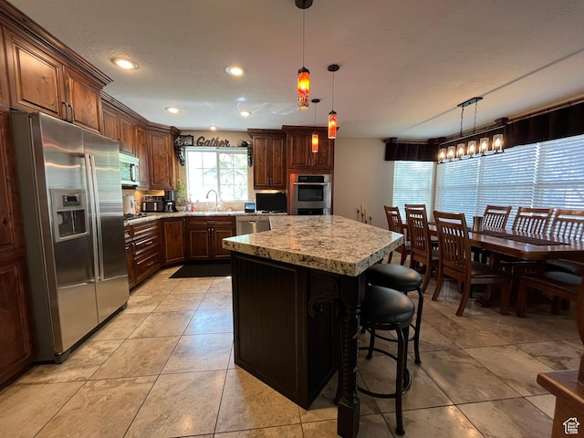 4863 Glasmann Way, Ogden, UT 84403 - kitchen featuring stainless steel appliances, a sink, a center island, decorative light fixtures, and recessed lighting