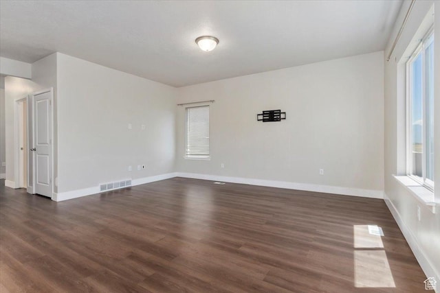 5621 W Stillwell Ln S, Herriman, UT 84096 - empty room with dark wood finished floors, baseboards, and plenty of natural light