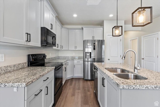 5621 W Stillwell Ln S, Herriman, UT 84096 - kitchen with black appliances, a sink, dark wood-style flooring, recessed lighting, and hanging light fixtures
