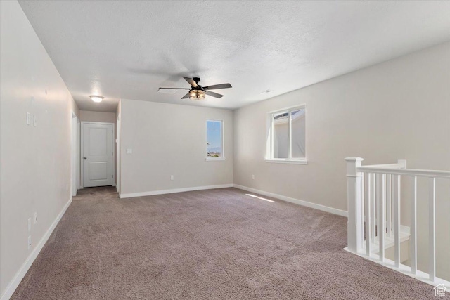 5621 W Stillwell Ln S, Herriman, UT 84096 - spare room with a ceiling fan, carpet flooring, baseboards, and a textured ceiling