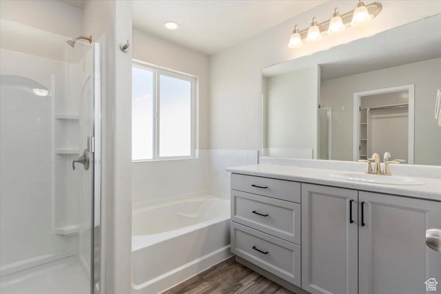 5621 W Stillwell Ln S, Herriman, UT 84096 - bathroom with a stall shower, vanity, a bath, and wood finished floors