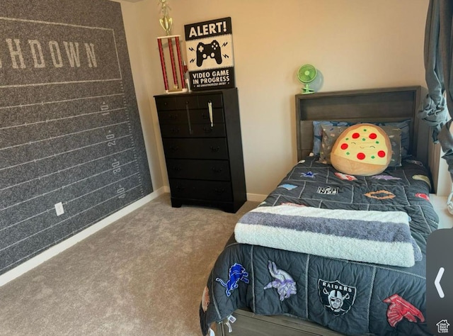 bedroom featuring carpet and baseboards