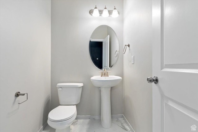 5621 W Stillwell Ln S, Herriman, UT 84096 - bathroom featuring marble look tiles, toilet, and baseboards