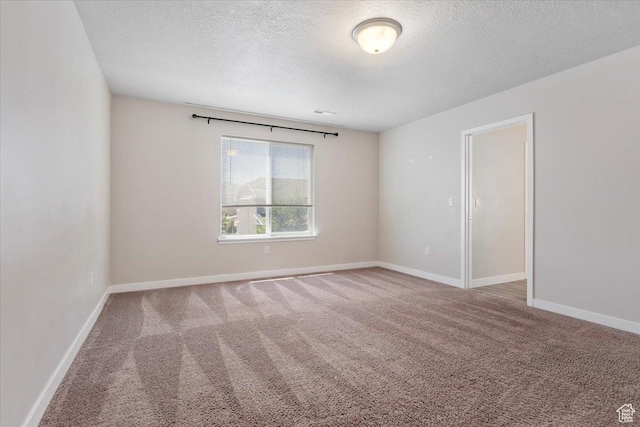5621 W Stillwell Ln S, Herriman, UT 84096 - empty room featuring a textured ceiling, carpet floors, and baseboards