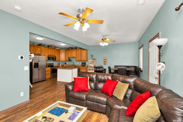 855 W 350 N, Tremonton, UT 84337 - living area featuring a ceiling fan, wood finished floors, and a textured ceiling