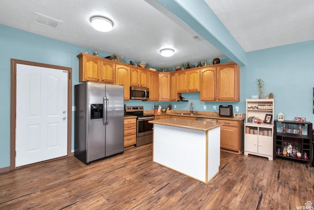 855 W 350 N, Tremonton, UT 84337 - kitchen featuring stainless steel appliances, a sink, dark wood-style floors, a center island, and light stone countertops