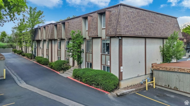 view of building exterior featuring uncovered parking