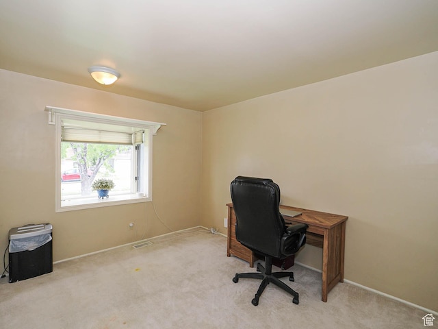 office space with baseboards and light colored carpet