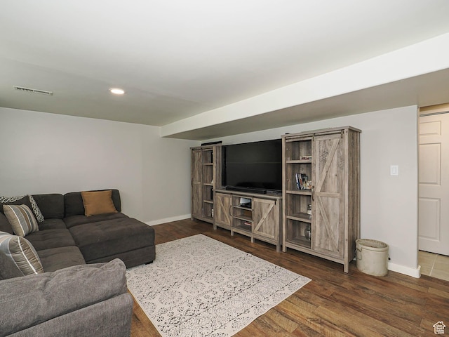 living room with baseboards, dark wood-type flooring, and recessed lighting