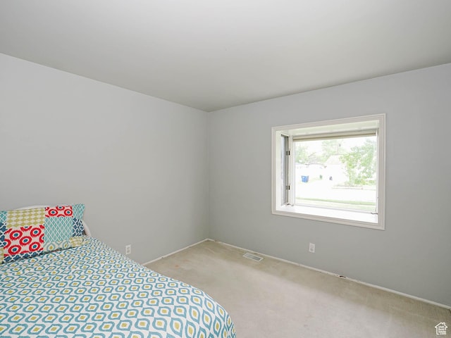 carpeted bedroom featuring baseboards