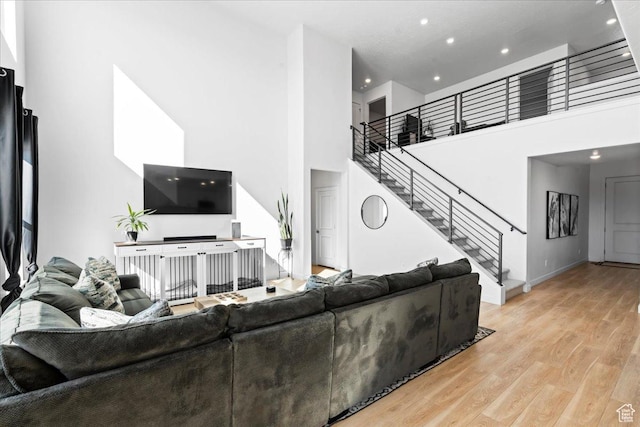 2102 S 2200 W, Woods Cross, UT 84087 - living room with stairway, light wood-style floors, a towering ceiling, recessed lighting, and baseboards