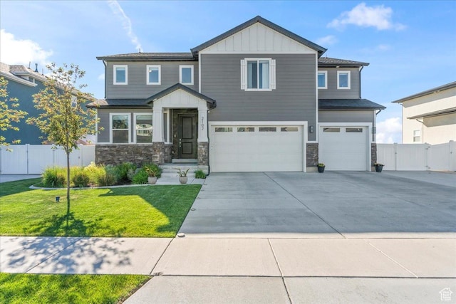 2102 S 2200 W, Woods Cross, UT 84087 - craftsman house featuring a garage, board and batten siding, driveway, stone siding, and a gate