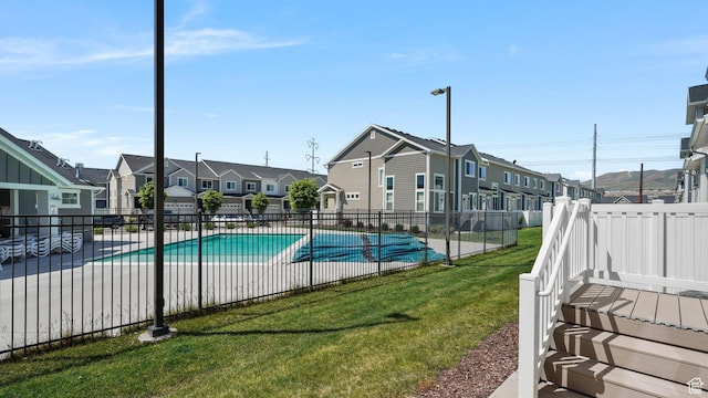 community pool featuring a residential view and a patio