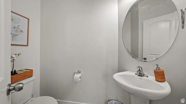 half bathroom with a sink and toilet