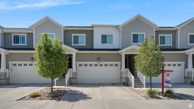 view of front of house featuring an attached garage, stucco siding, and concrete driveway