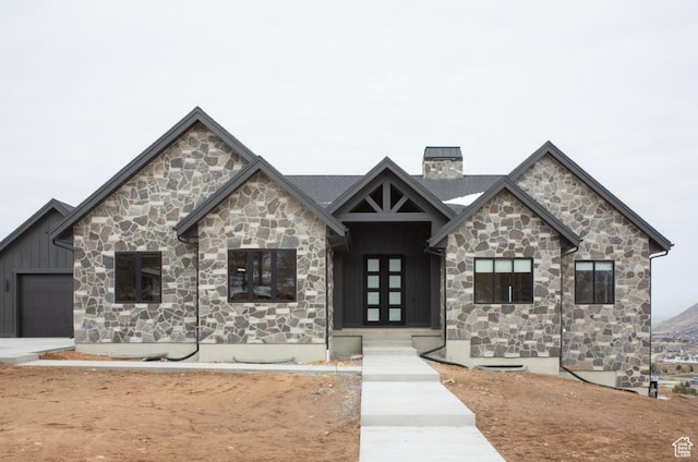 443 W 1200 N Unit 3, Mapleton, UT 84664 - view of front of home featuring stone siding, board and batten siding, a chimney, and an attached garage