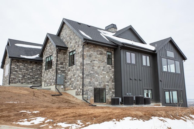 443 W 1200 N Unit 3, Mapleton, UT 84664 - view of snowy exterior featuring stone siding, board and batten siding, cooling unit, and a chimney