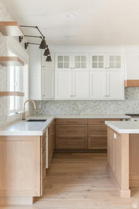 9856 N Sorrel Dr, Eagle Mountain, UT 84005 - kitchen featuring a sink, white cabinets, light wood-type flooring, and light countertops