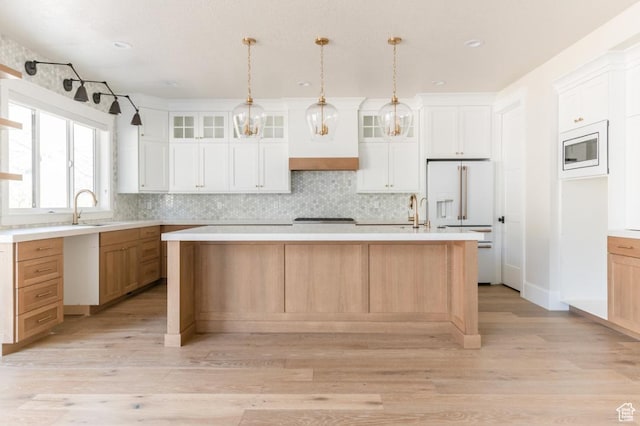 9856 N Sorrel Dr, Eagle Mountain, UT 84005 - kitchen featuring high end fridge, light wood-type flooring, backsplash, a sink, and recessed lighting